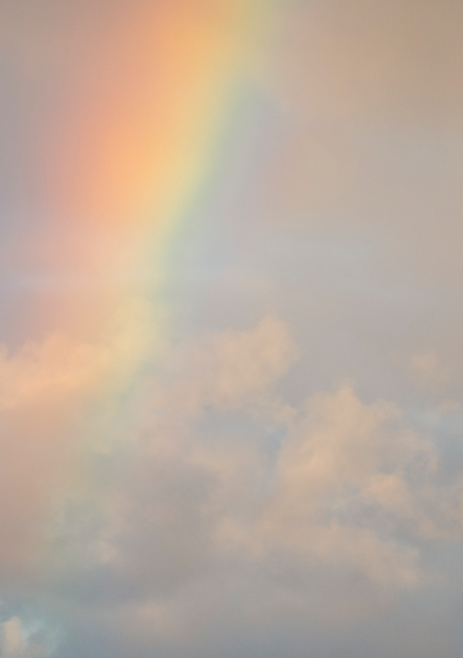 photograph of a close up rainbow and clouds